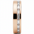 Rose gold ring with diamond accents in a channel with white background